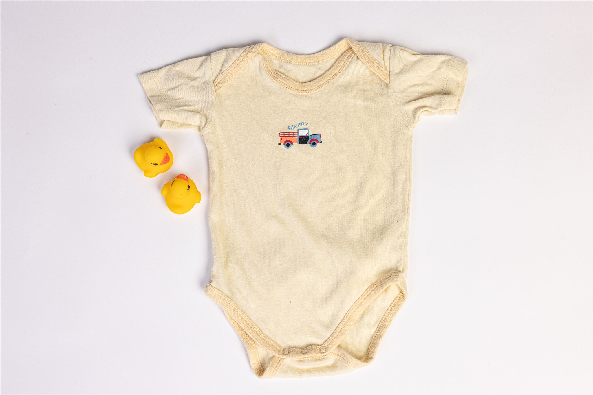 Baby bodysuit with bakery truck print