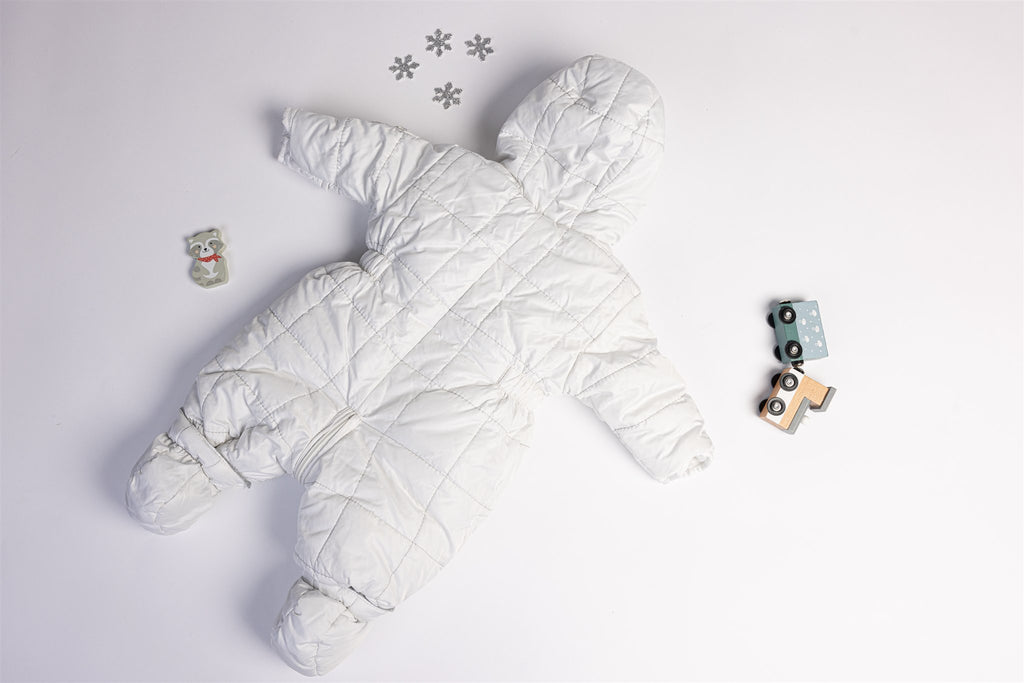 White quilted pramsuit with elephant badge