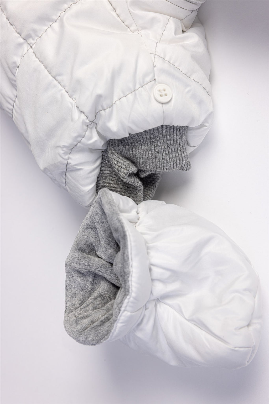 White quilted pramsuit with elephant badge