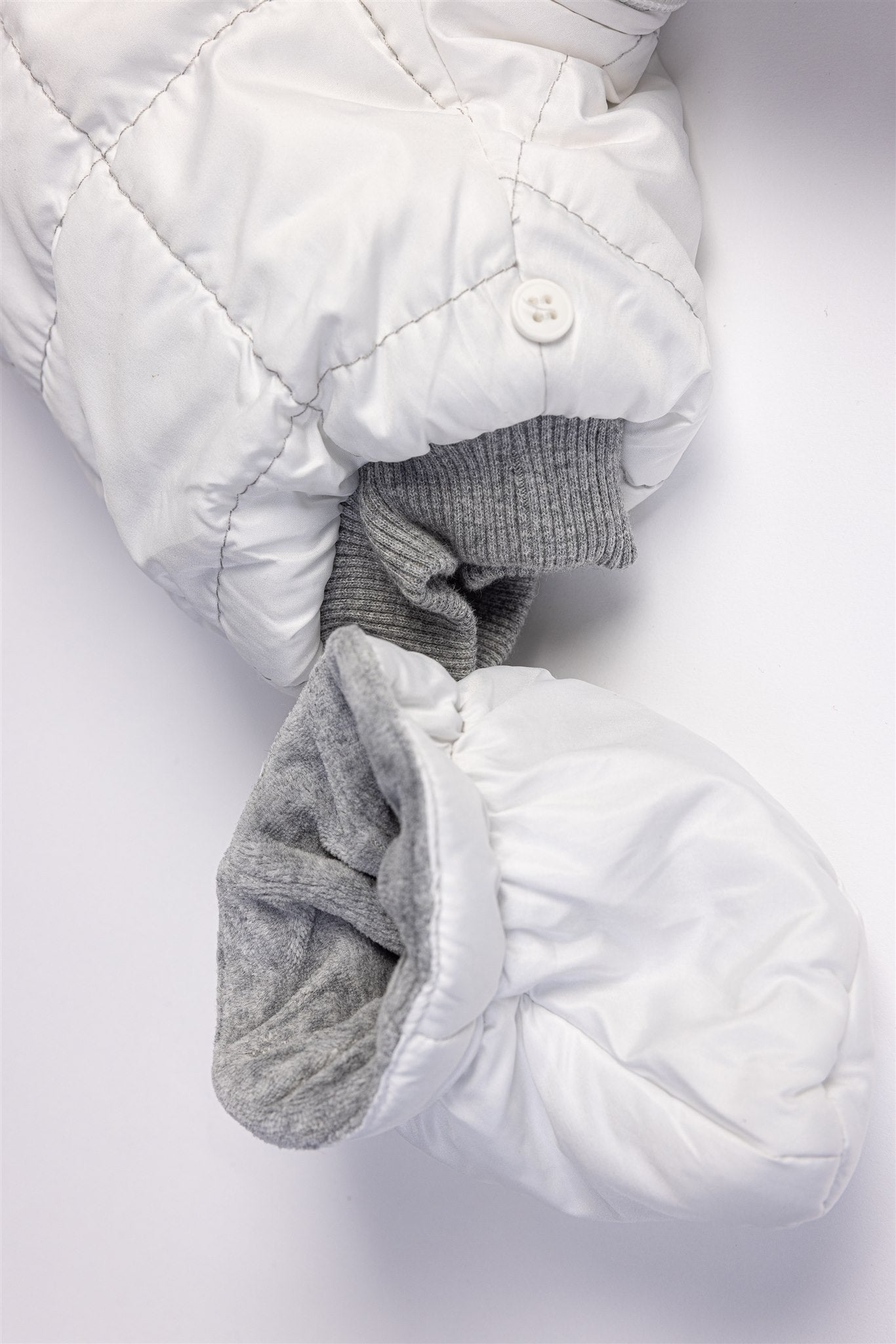 White quilted pramsuit with elephant badge