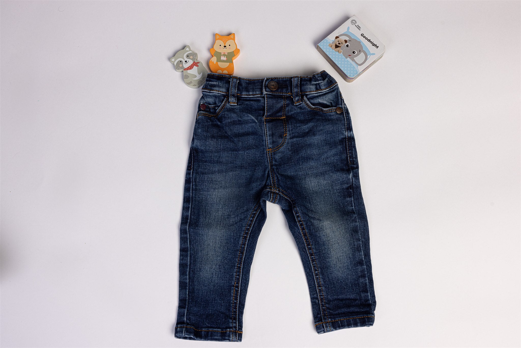 Blue jeans with dinosaur on the back