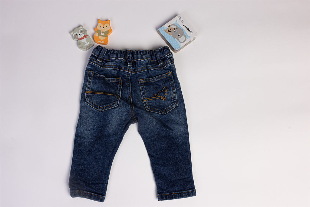 Blue jeans with dinosaur on the back