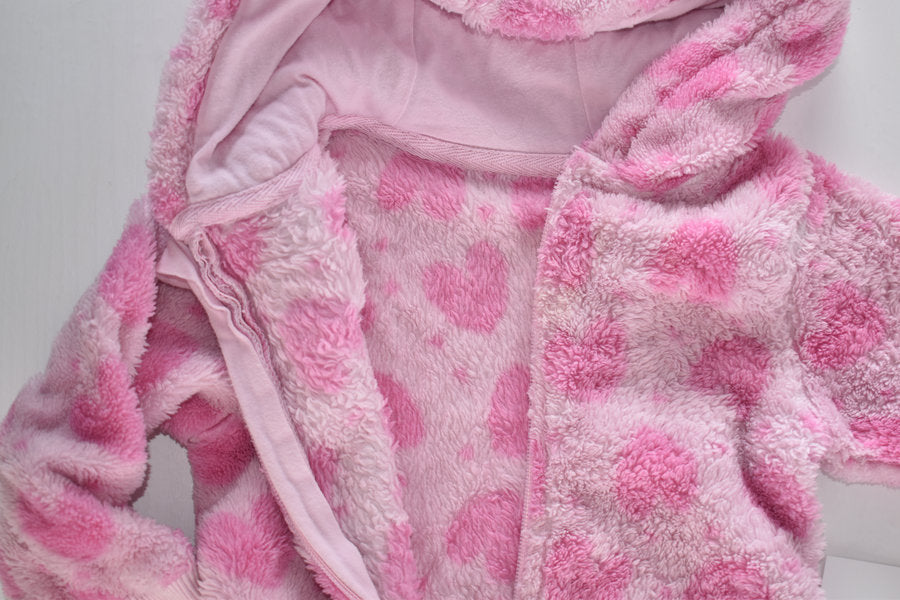 Pink fleece pramsuit with heart pattern