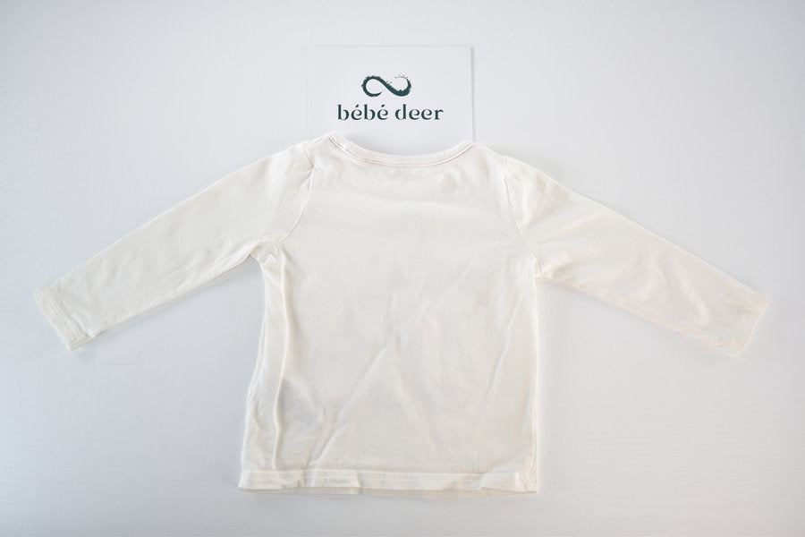 Cream long-sleeved top with interactive castle design