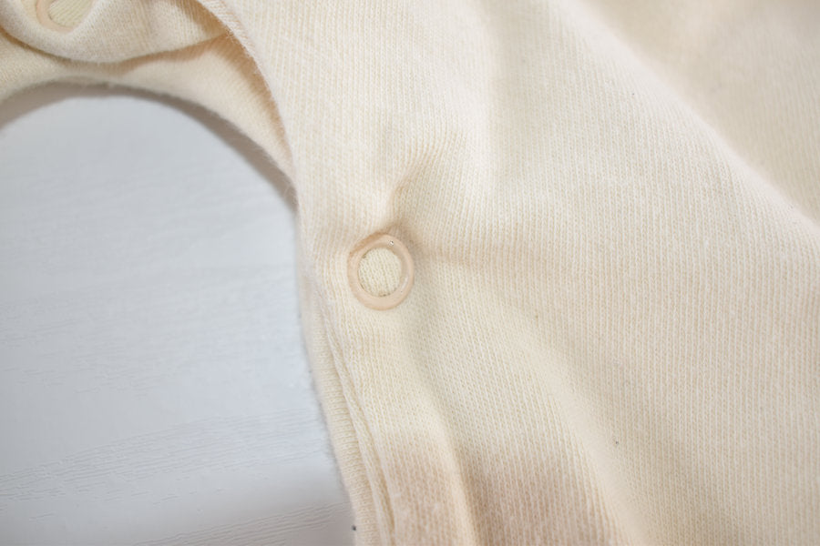 Cream sleepsuit featuring lace ruffle details