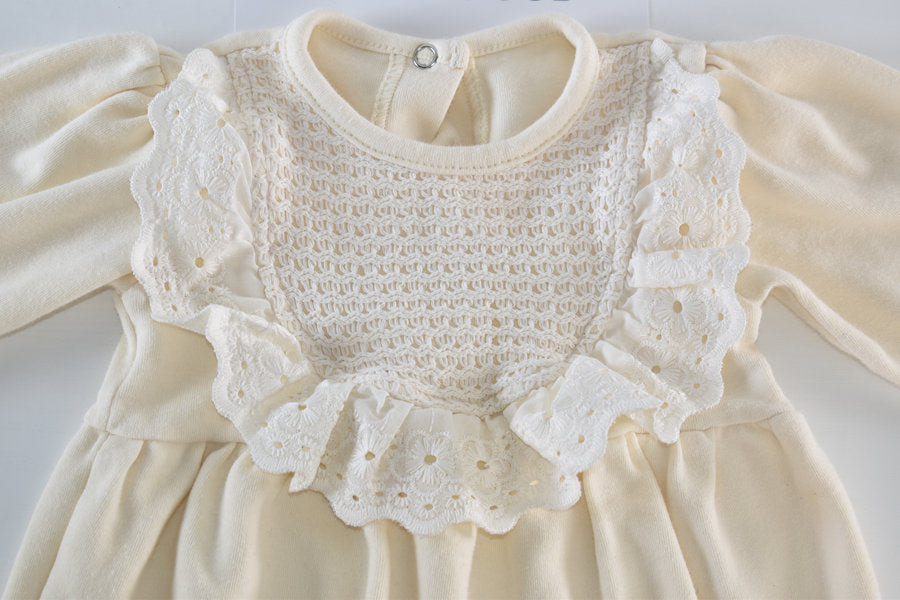 Cream sleepsuit featuring lace ruffle details