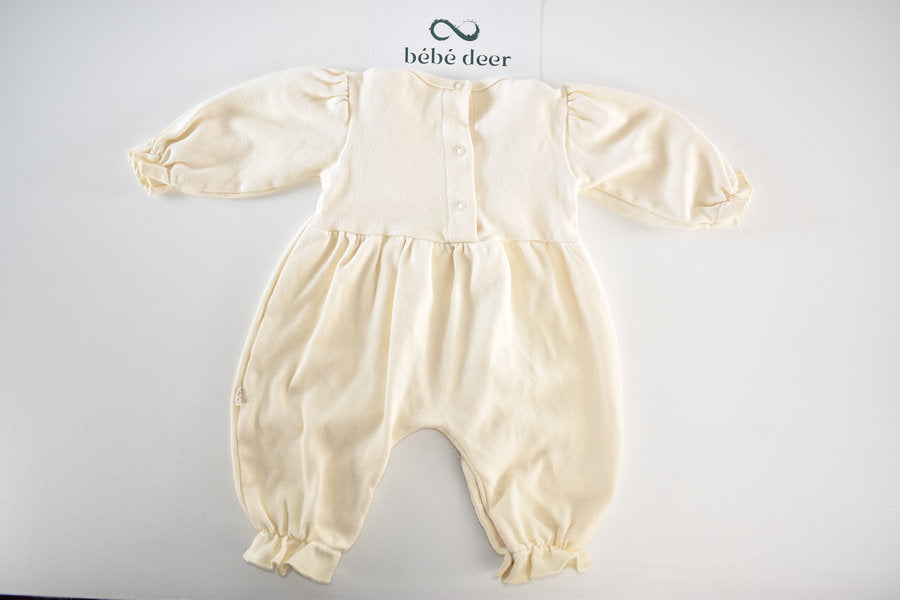 Cream sleepsuit featuring lace ruffle details