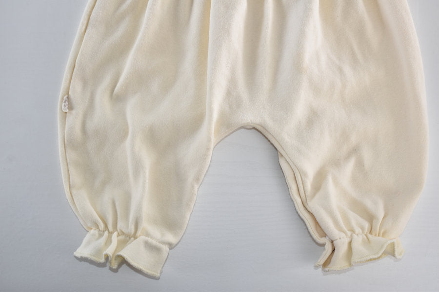 Cream sleepsuit featuring lace ruffle details