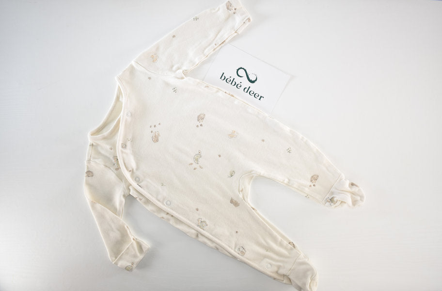 Cream sleepsuit featuring animal print