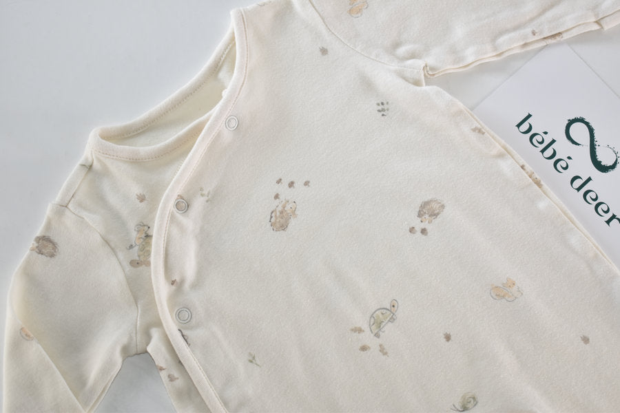 Cream sleepsuit featuring animal print