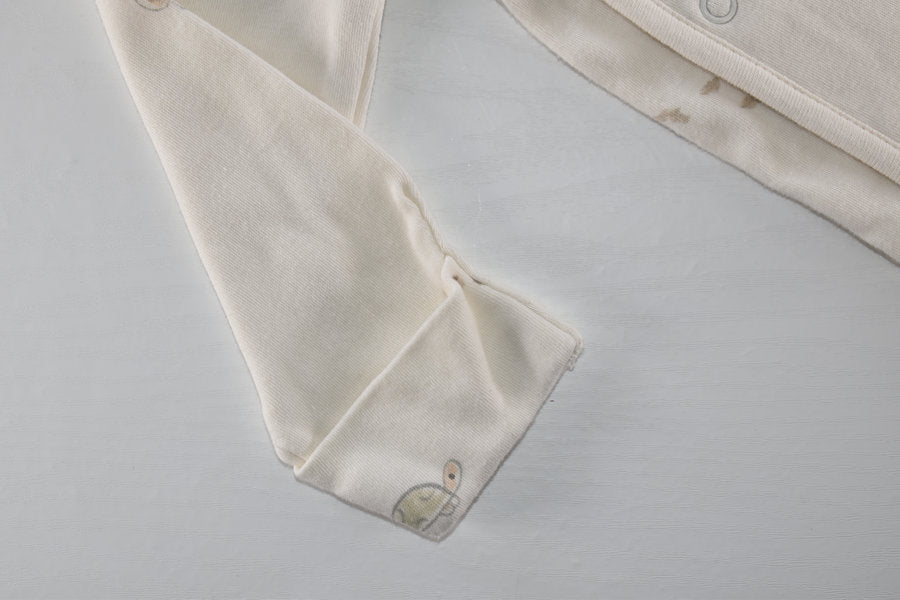 Cream sleepsuit featuring animal print