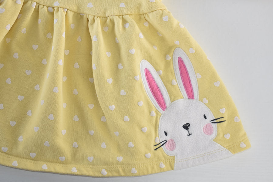 Yellow dress with white heart pattern and a bunny