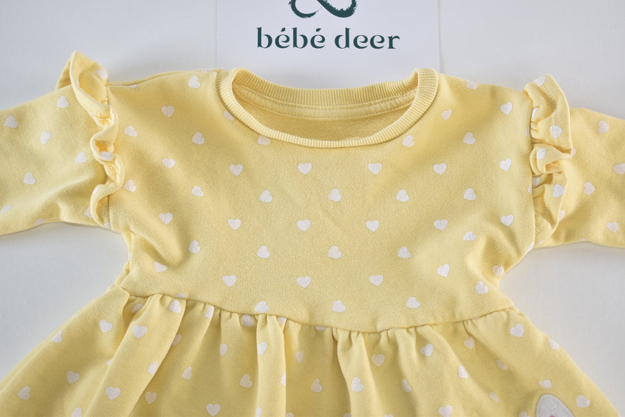 Yellow dress with white heart pattern and a bunny