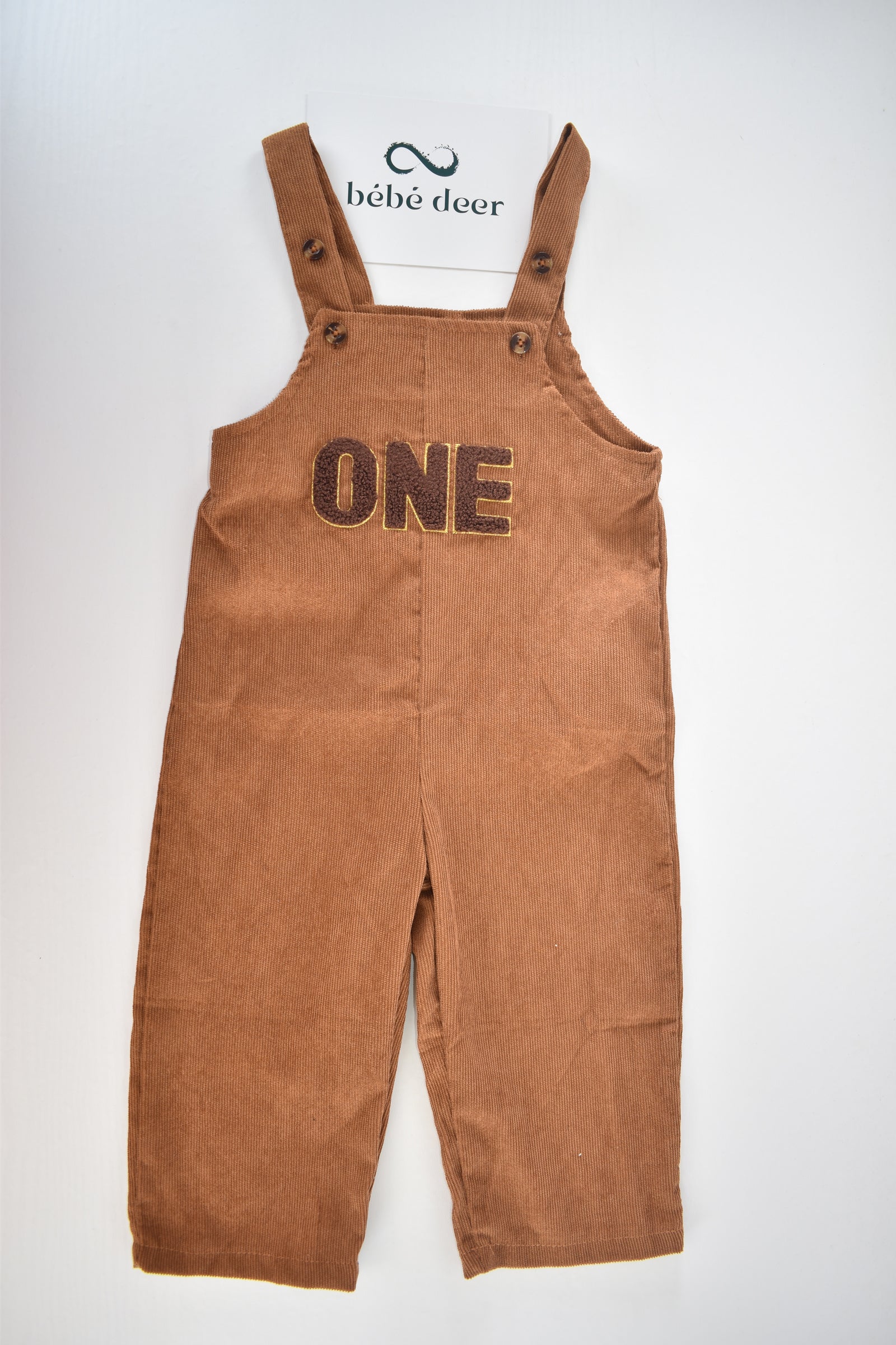 Brown cord dungarees with "ONE" appliqué