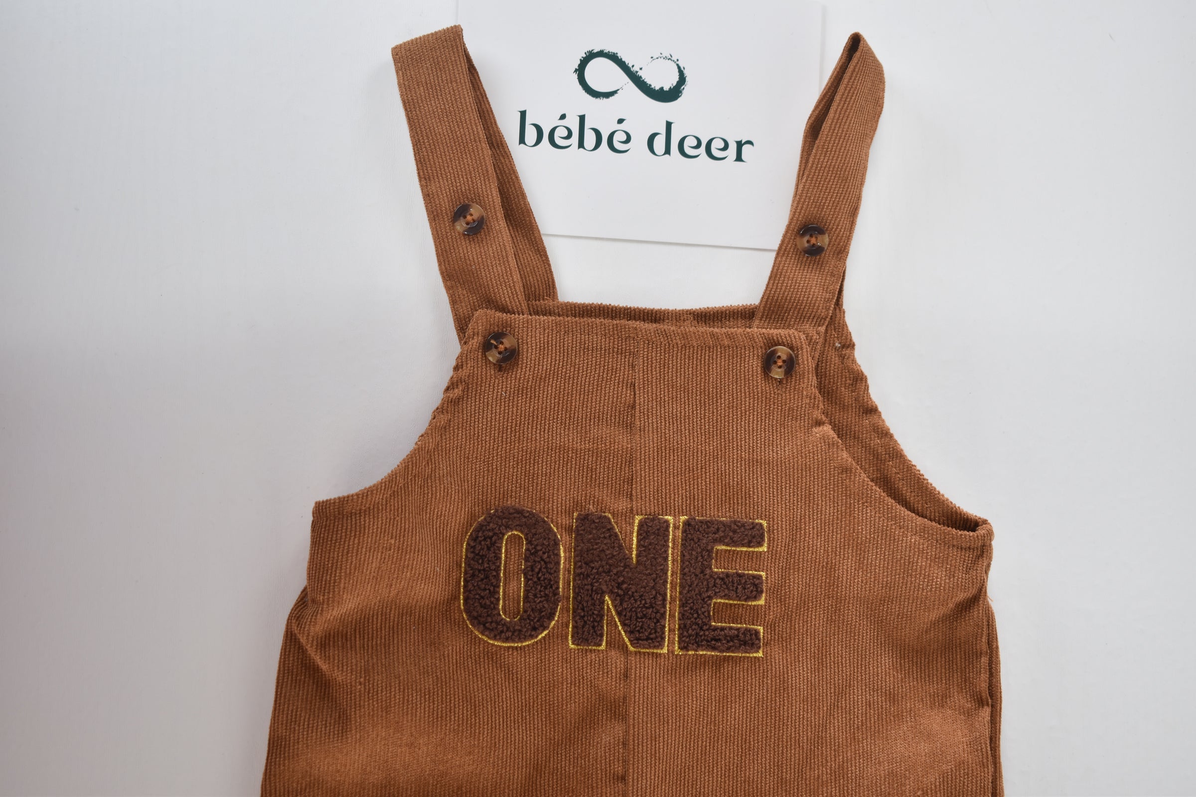 Brown cord dungarees with "ONE" appliqué