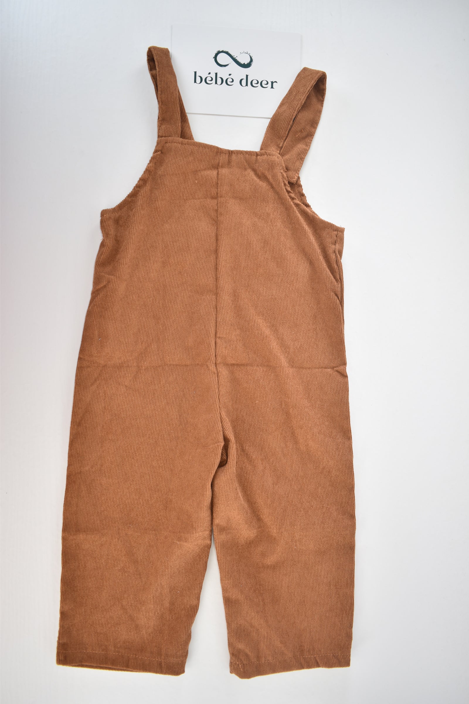 Brown cord dungarees with "ONE" appliqué