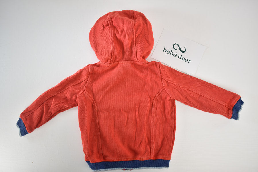 Veste orange à capuche zippée avec écusson brodé