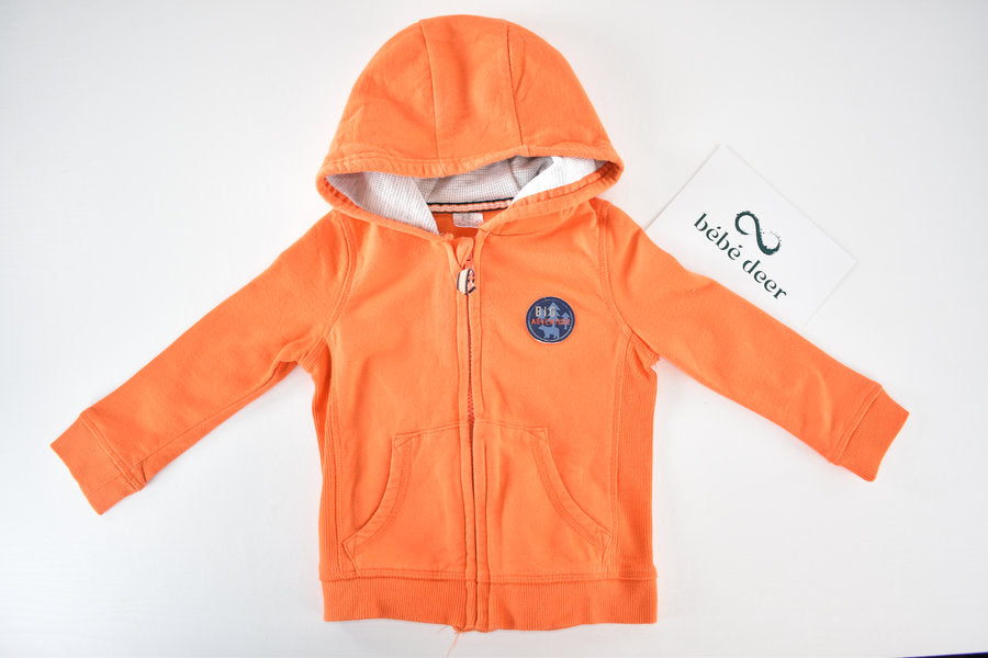 Orange hooded jacket with Big Adventure badge