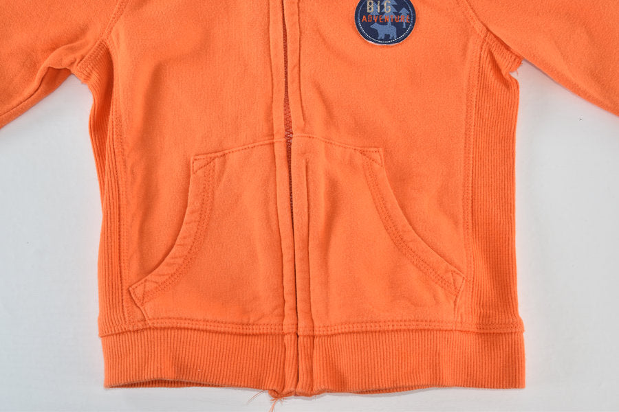 Orange hooded jacket with Big Adventure badge