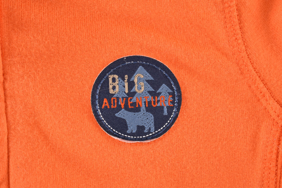 Orange hooded jacket with Big Adventure badge