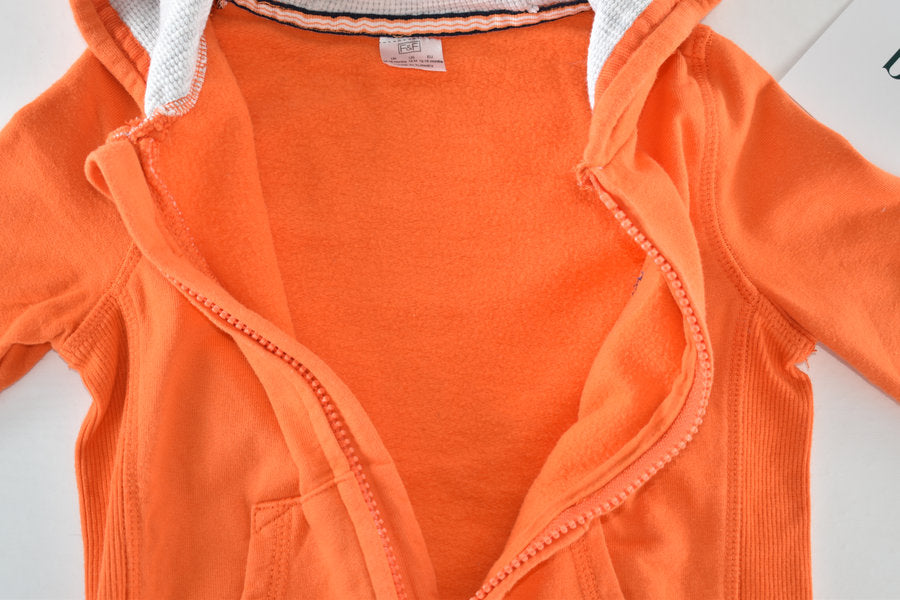 Orange hooded jacket with Big Adventure badge