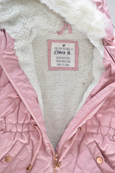 Pink quilted hooded coat with faux fur trim