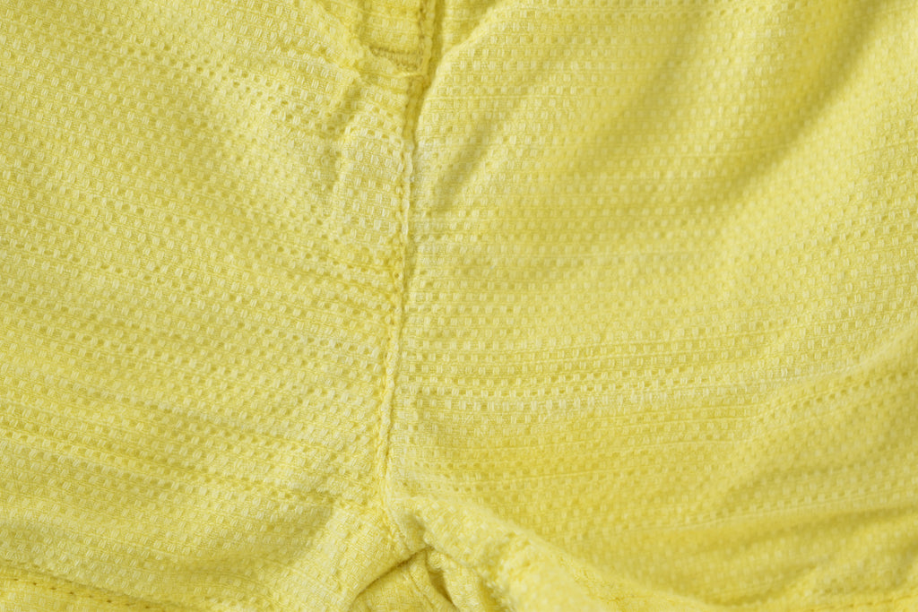 Yellow textured shorts with ruffle details