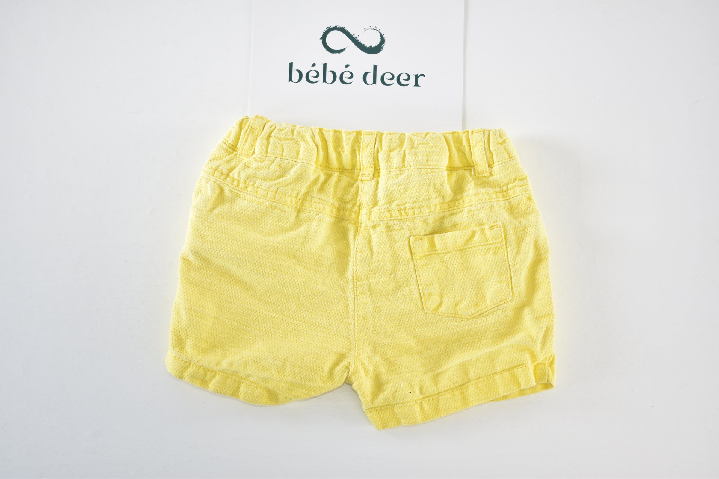 Yellow textured shorts with ruffle details