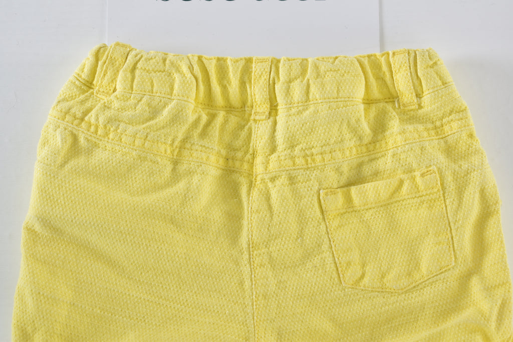 Yellow textured shorts with ruffle details