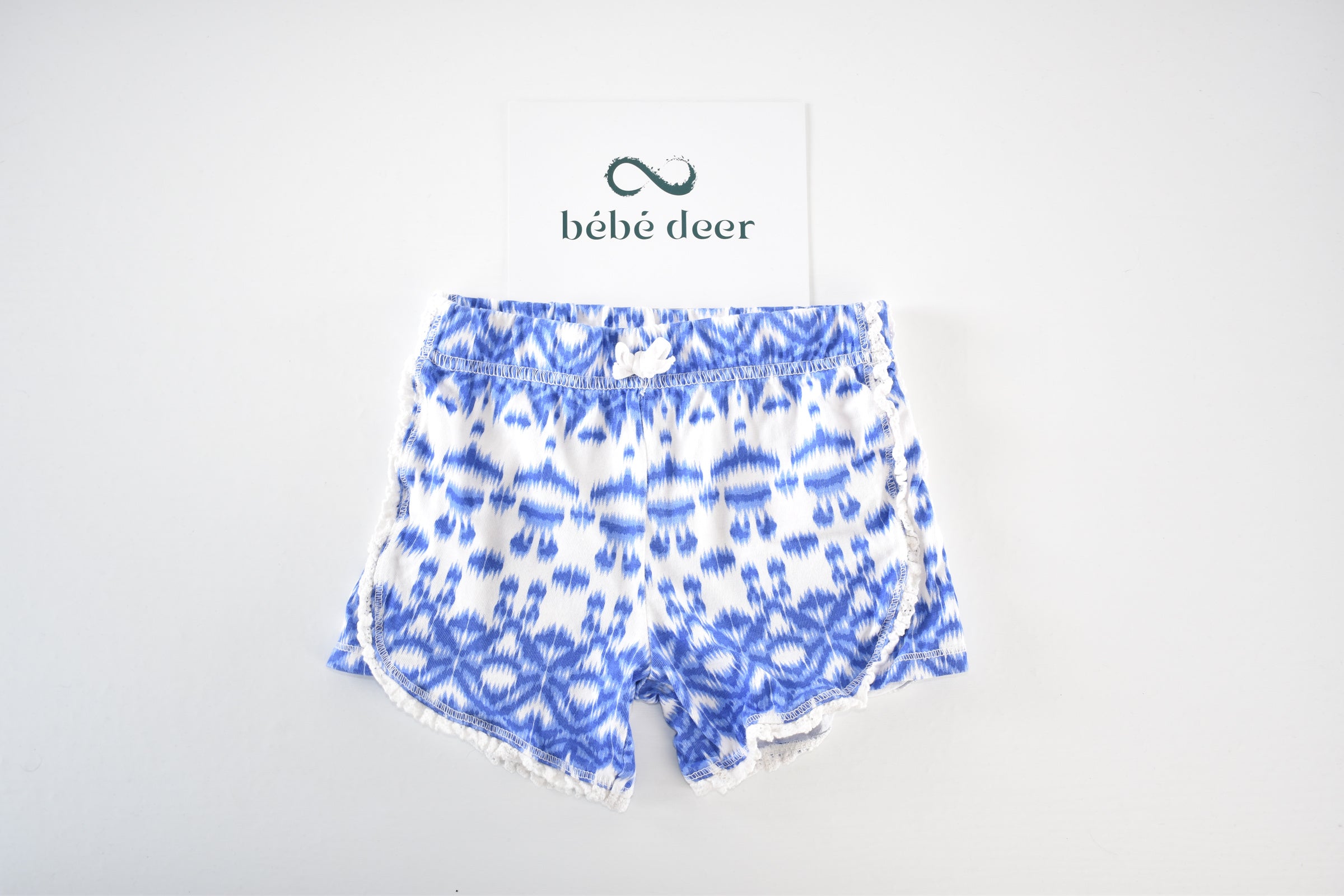 Blue patterned shorts with pom-pom trim
