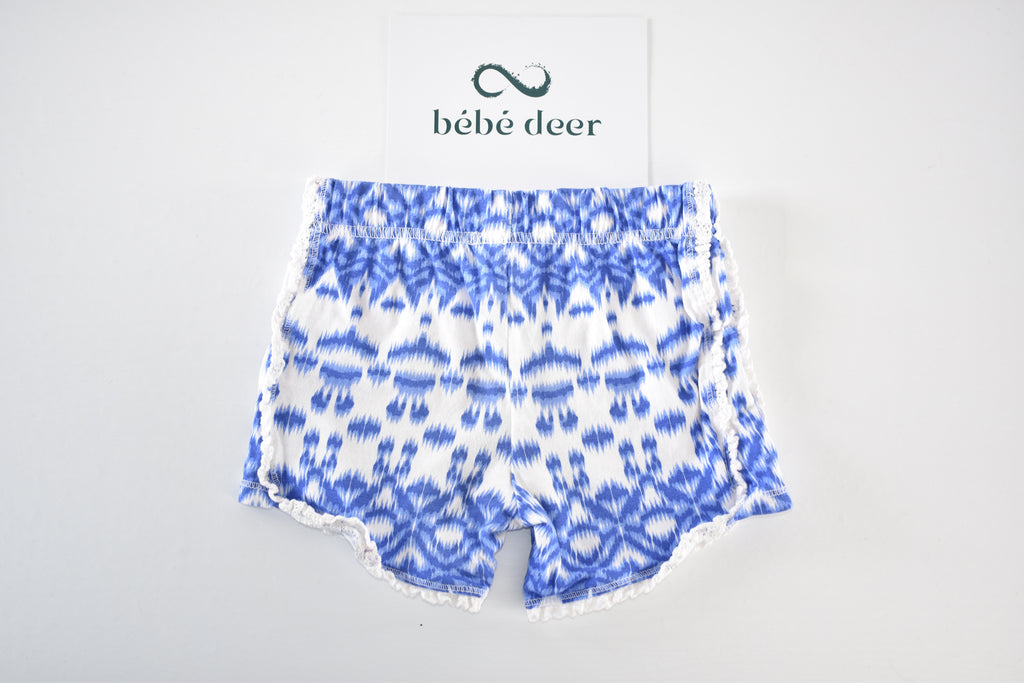 Blue patterned shorts with pom-pom trim
