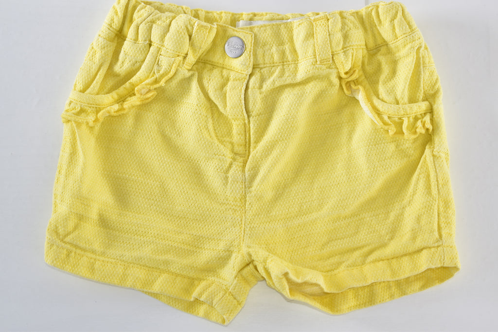 Yellow textured shorts with ruffle details
