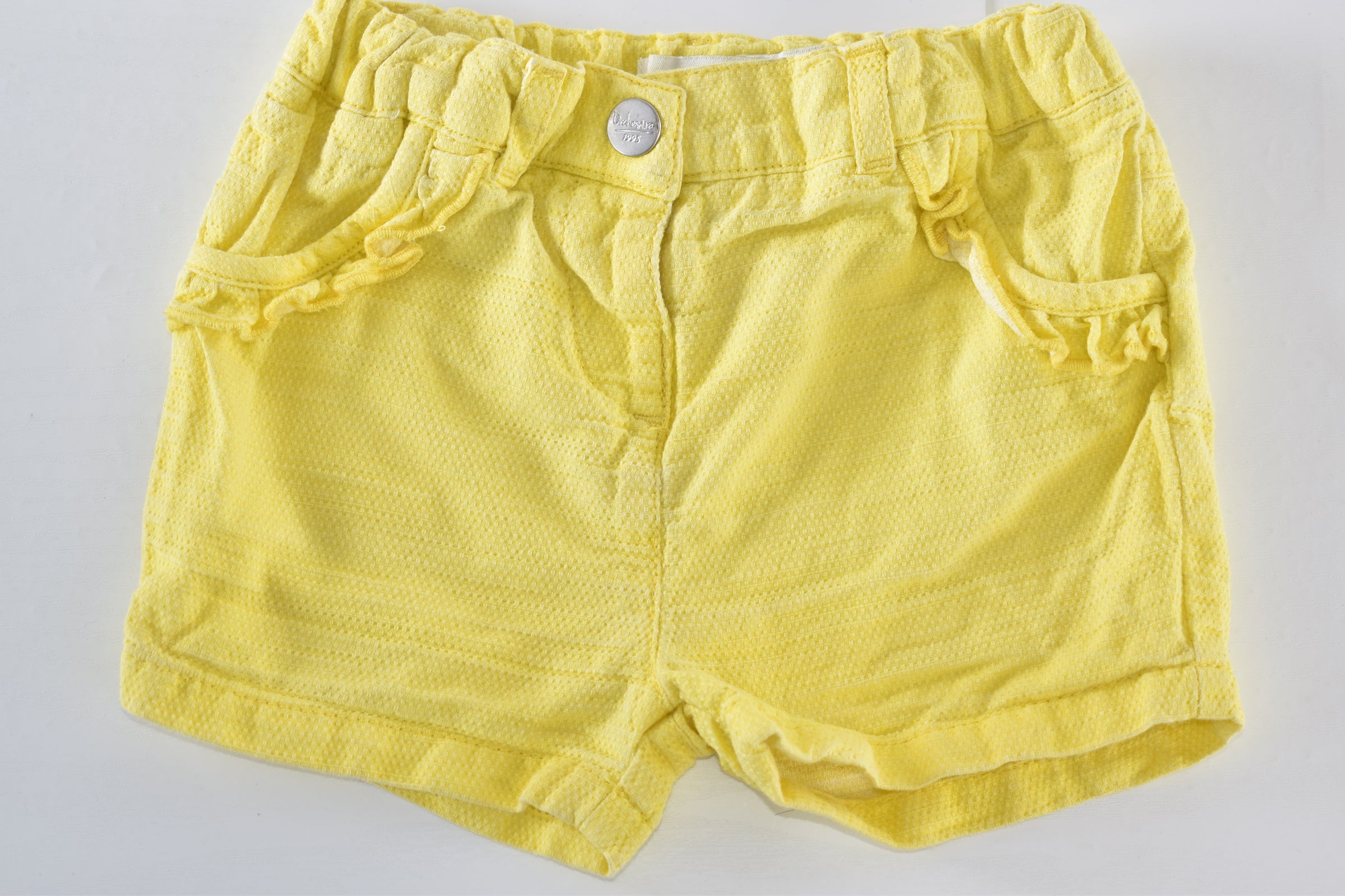 Yellow textured shorts with ruffle details