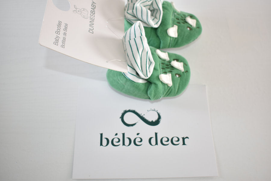 Newborn booties with dinosaur detail