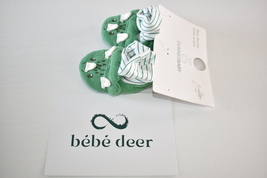 Newborn booties with dinosaur detail