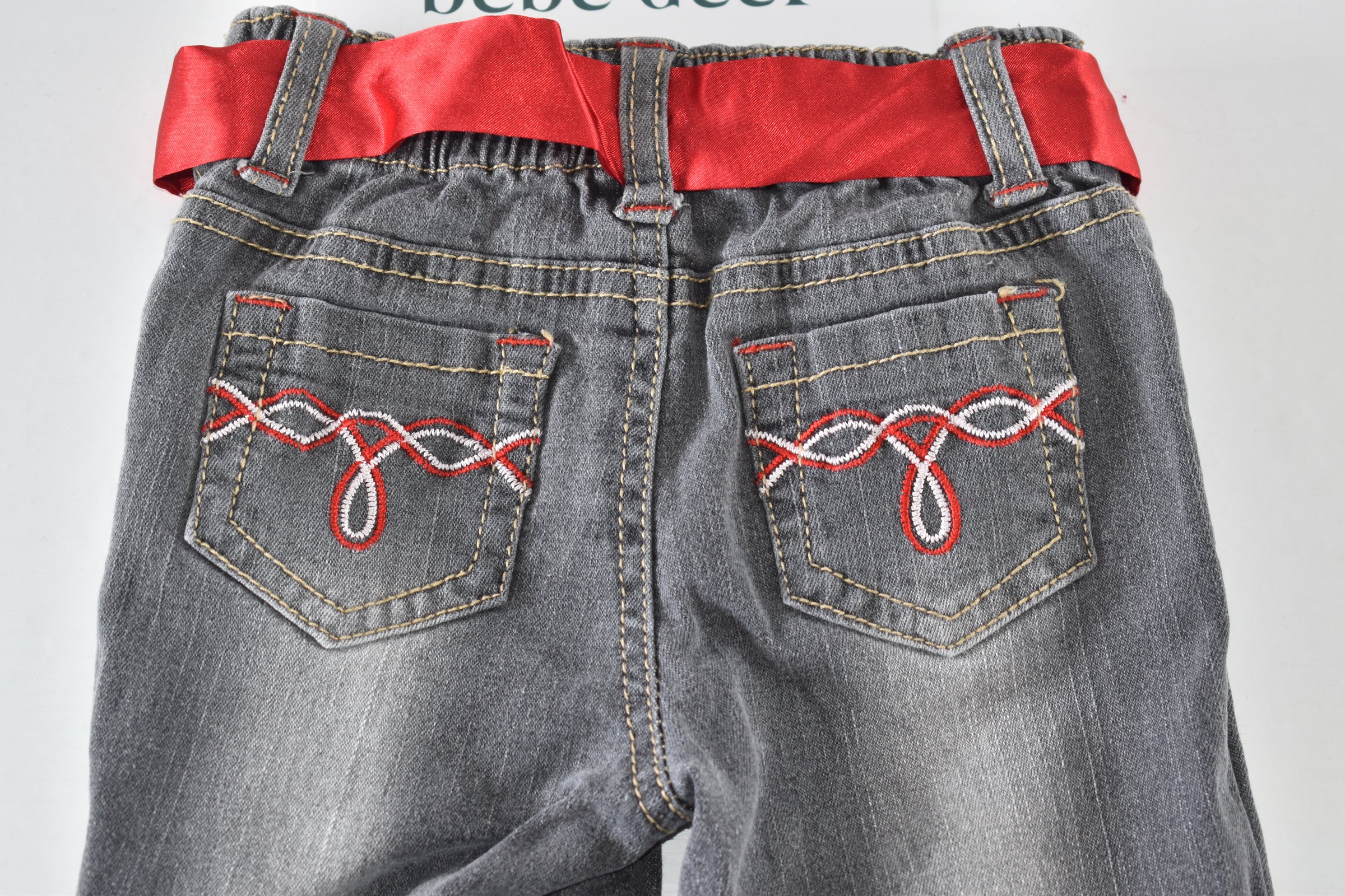 Butterfly embroidered jeans with red belt