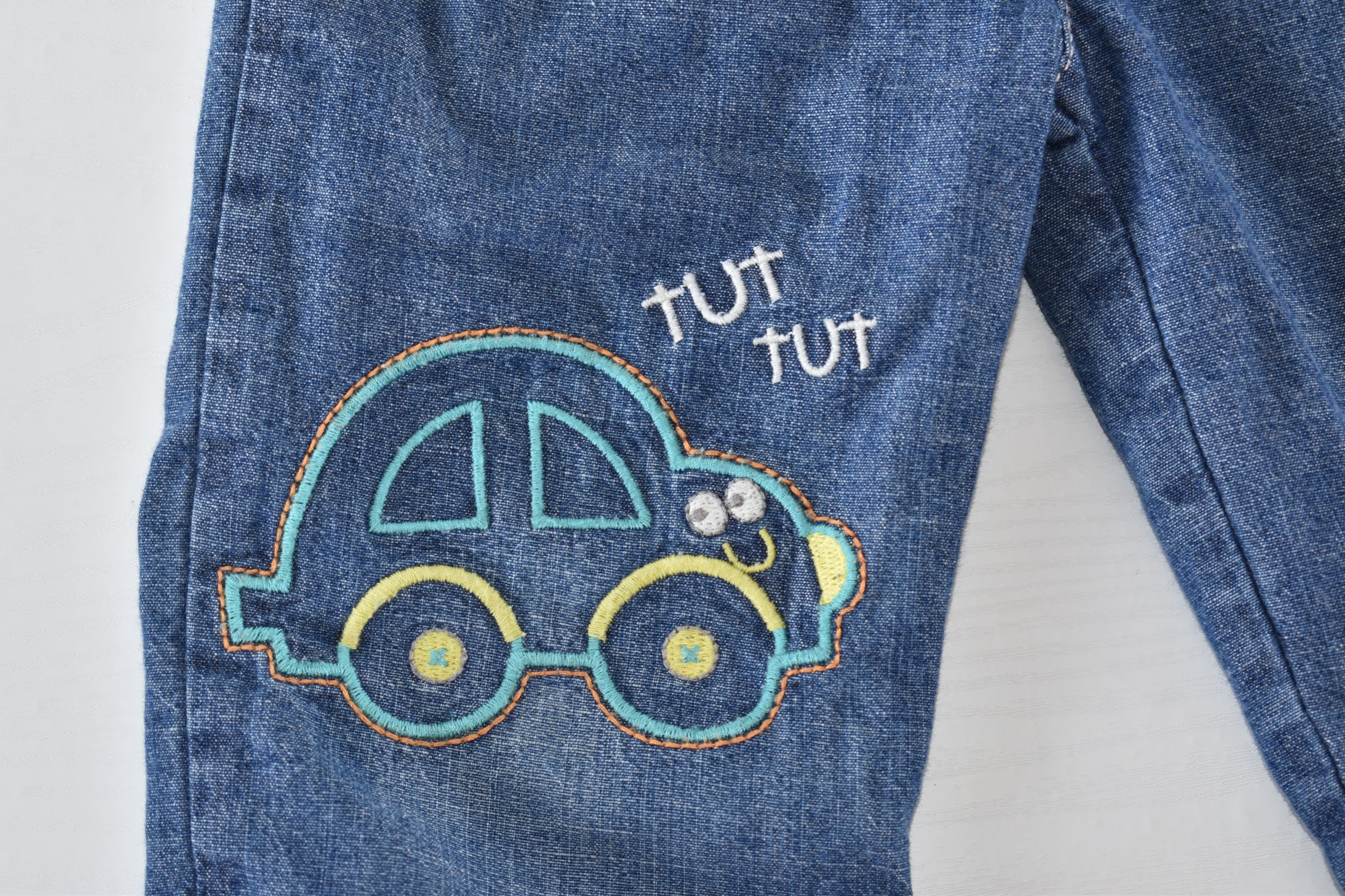 Denim trousers with embroidered car