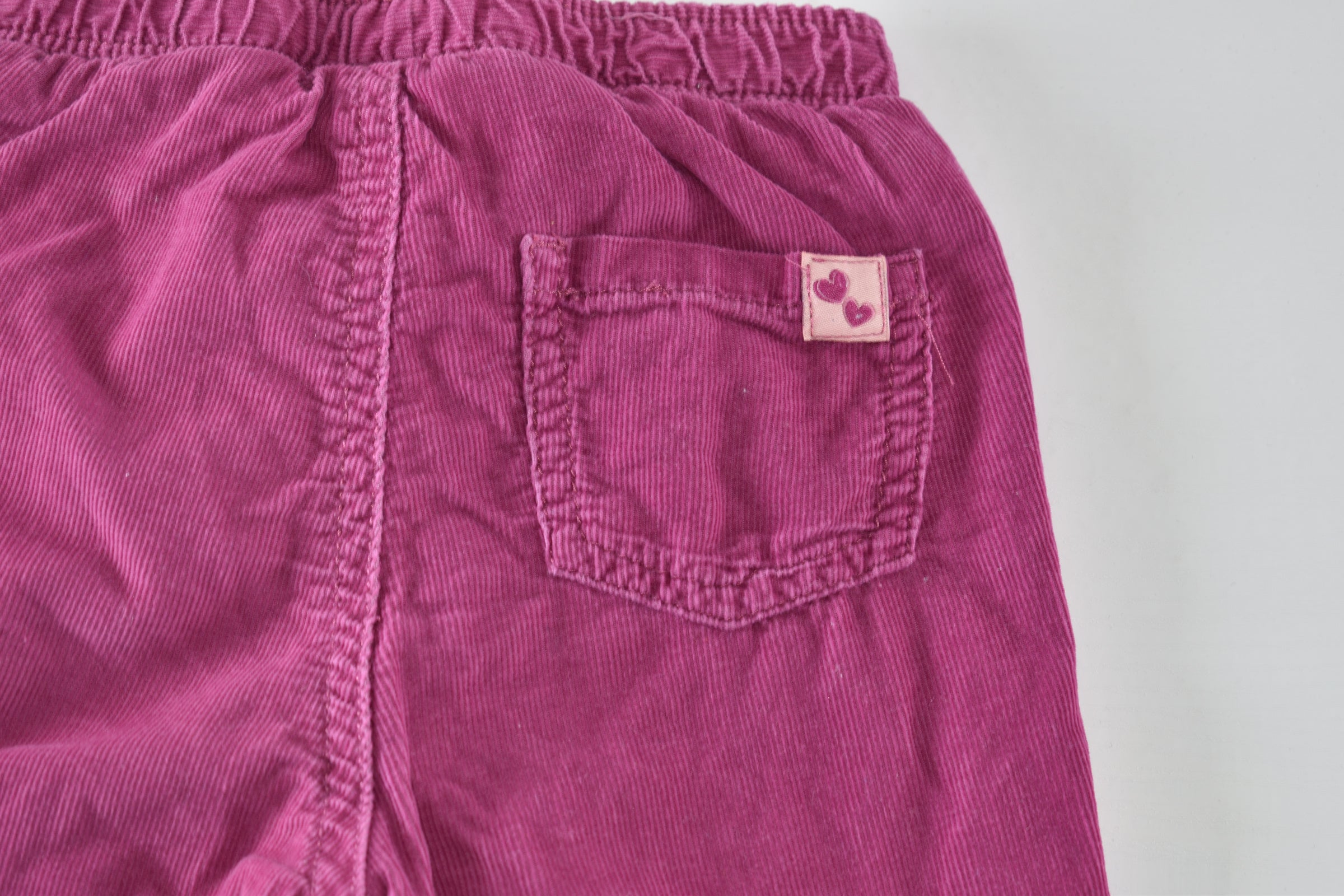 Bright pink lined corduroy trousers