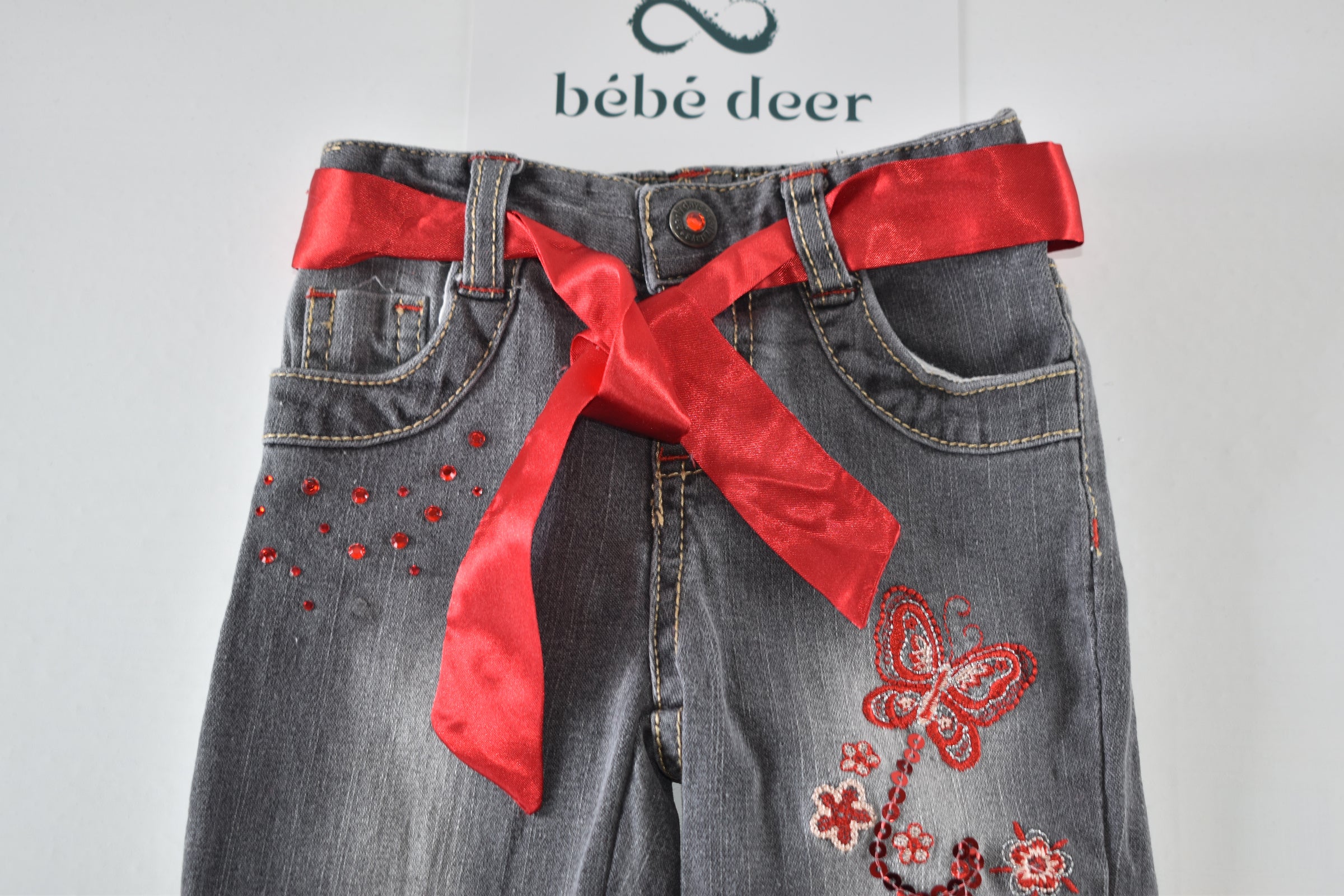 Butterfly embroidered jeans with red belt