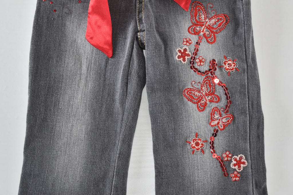Butterfly embroidered jeans with red belt
