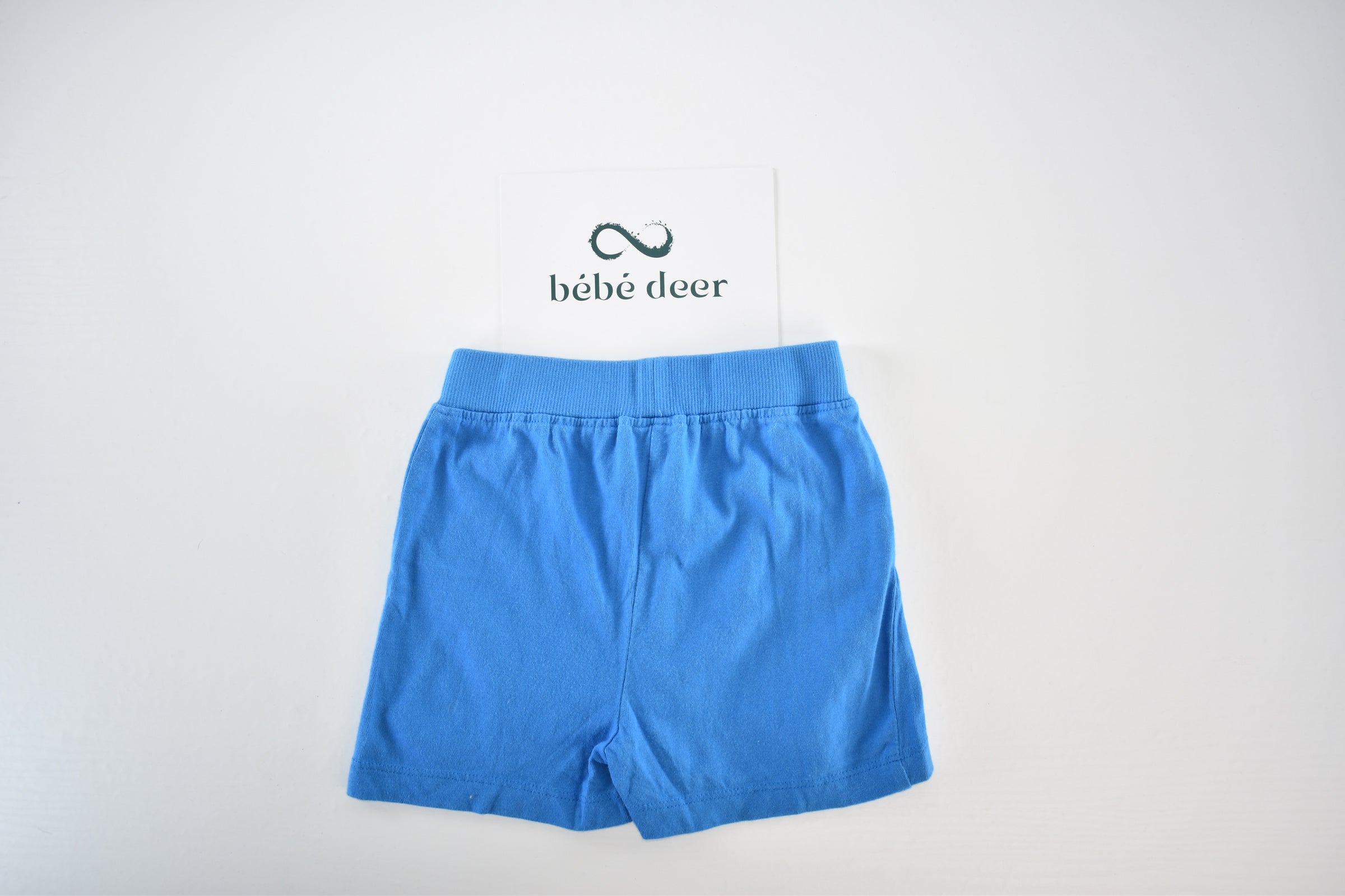 Bright blue jersey shorts with decorative pockets
