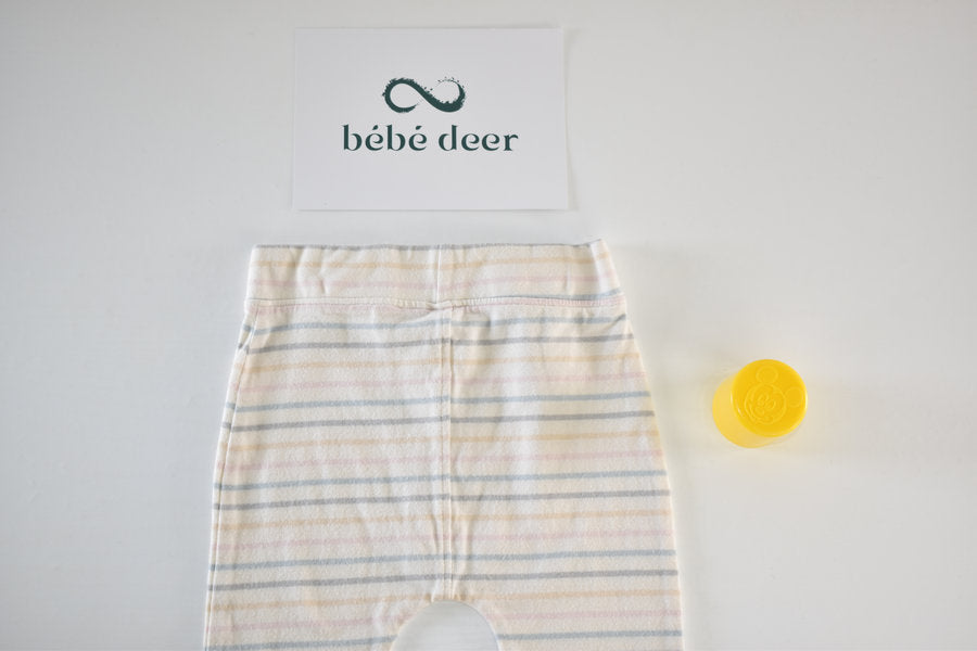 Cream trousers with pastel stripe pattern