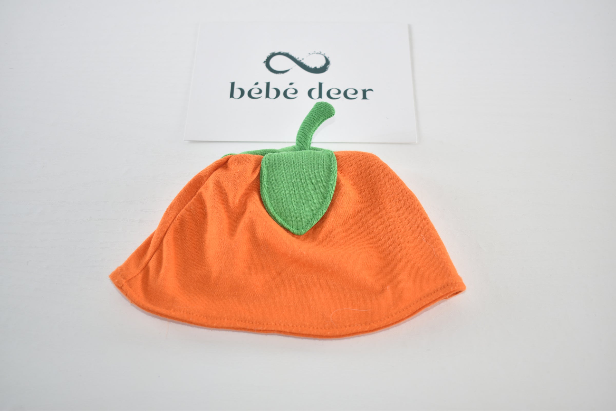 Pumpkin baby hat with green leaf detail