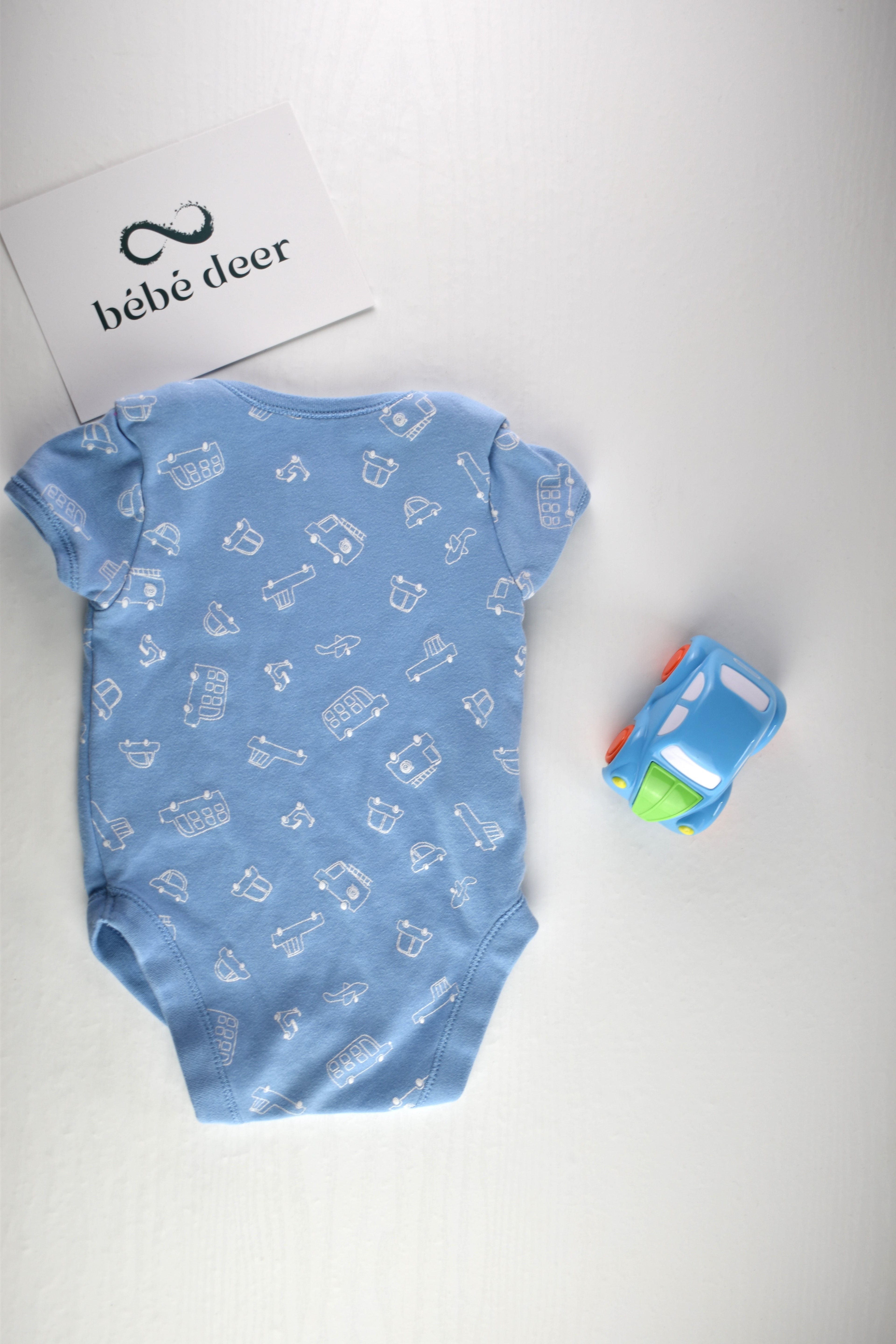 Light blue bodysuit with white vehicle print