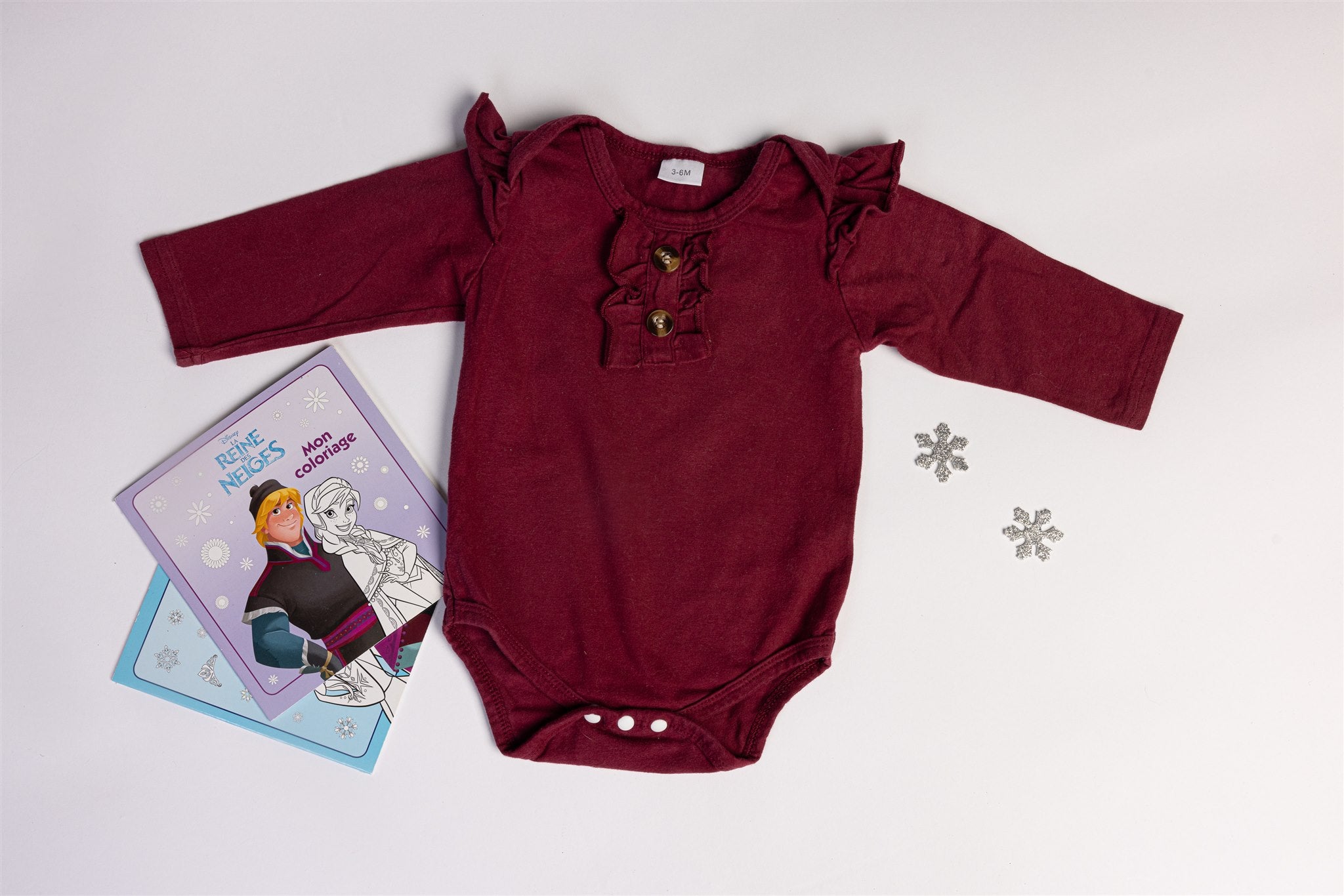 Burgundy bodysuit with decorative buttons