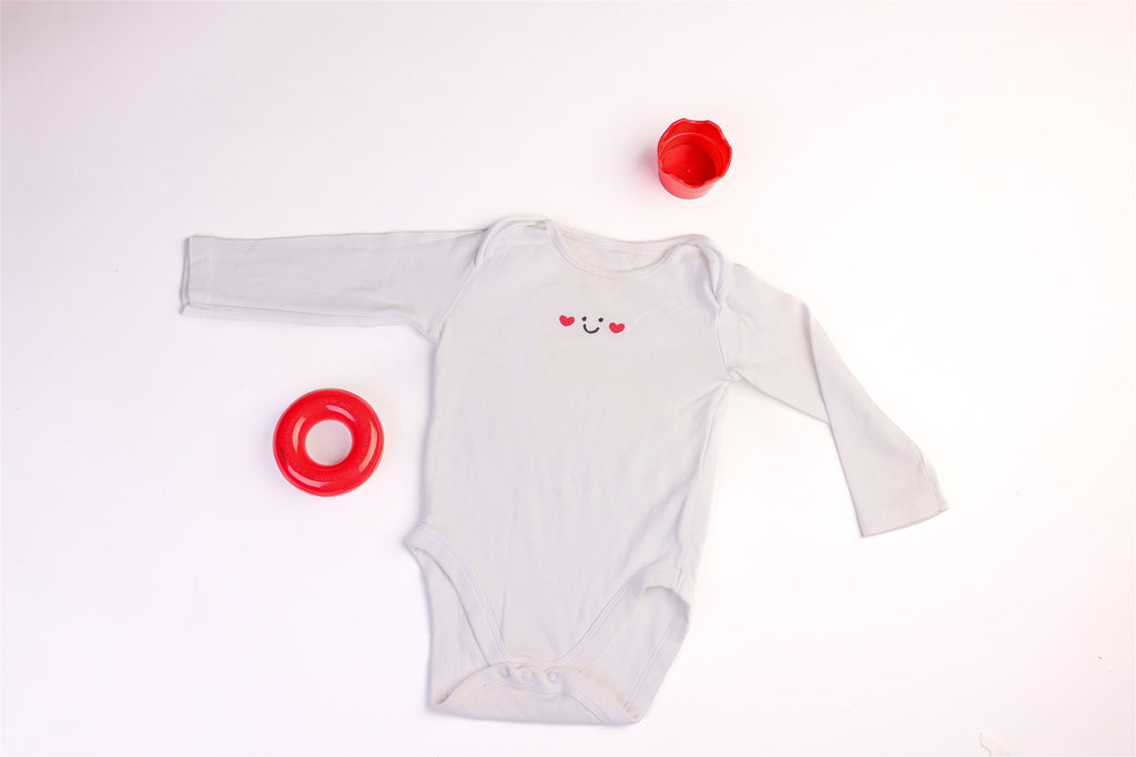 Long-sleeved bodysuit with a smile and a little heart
