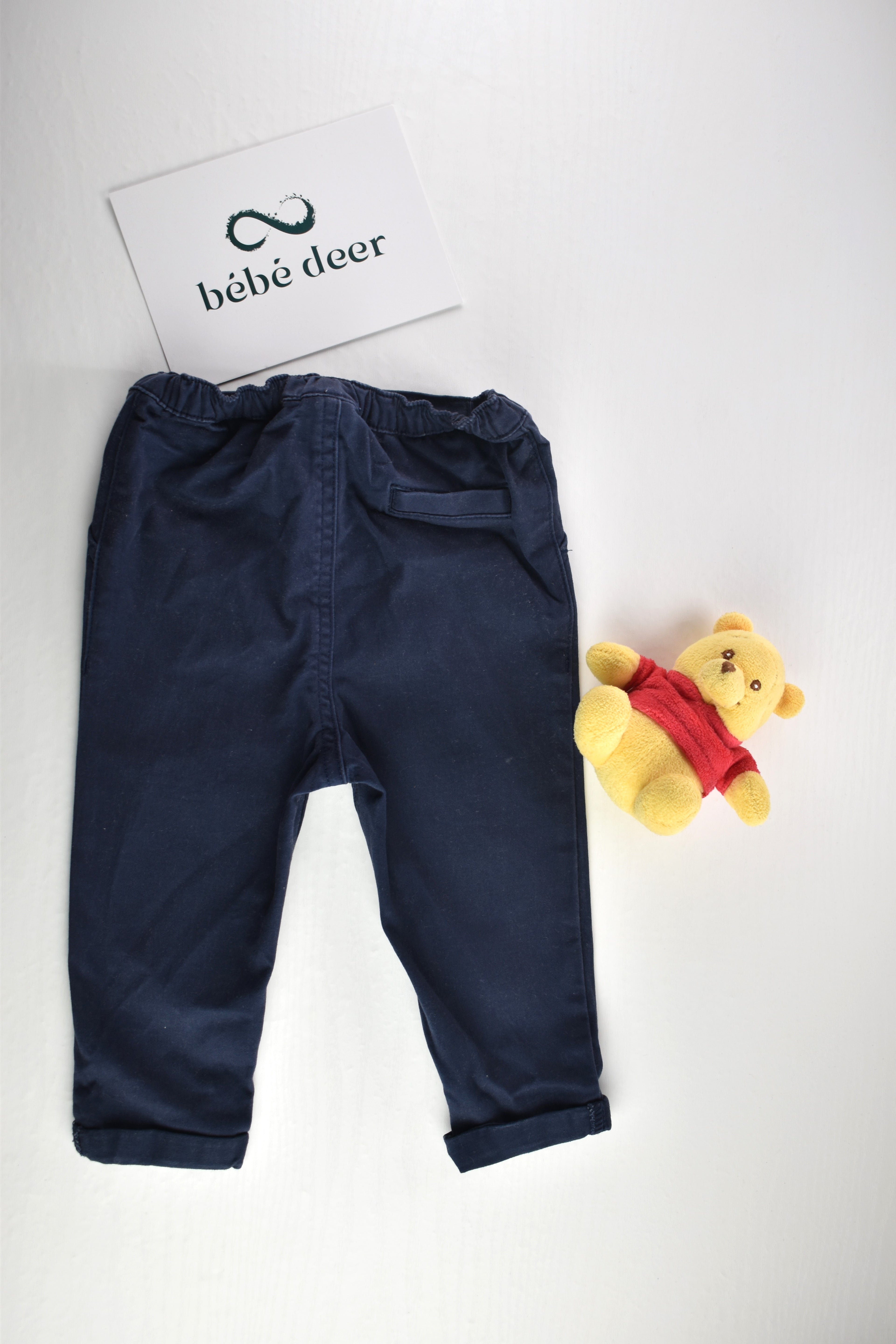 Navy trousers with a decorative button