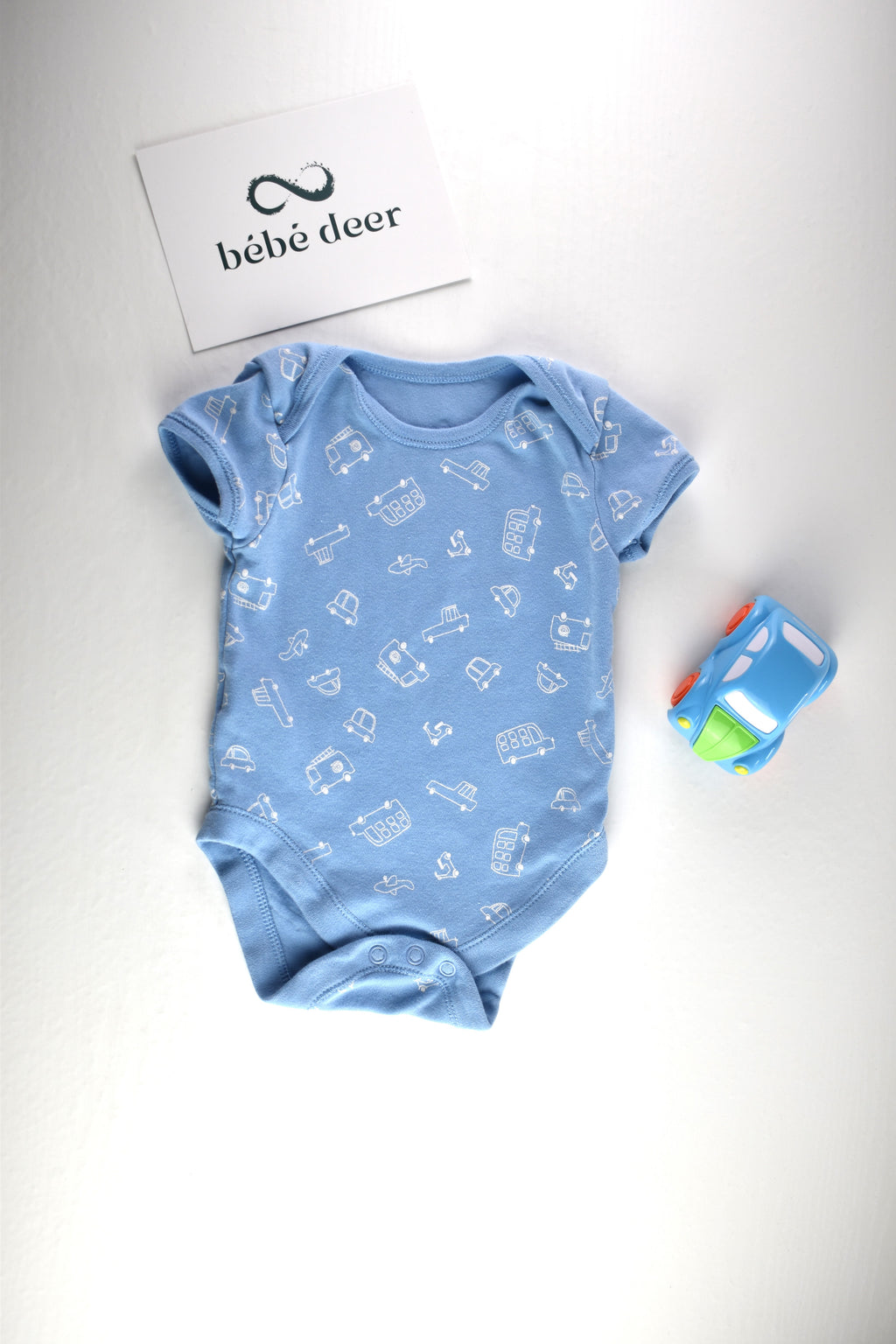 Light blue bodysuit with white vehicle print