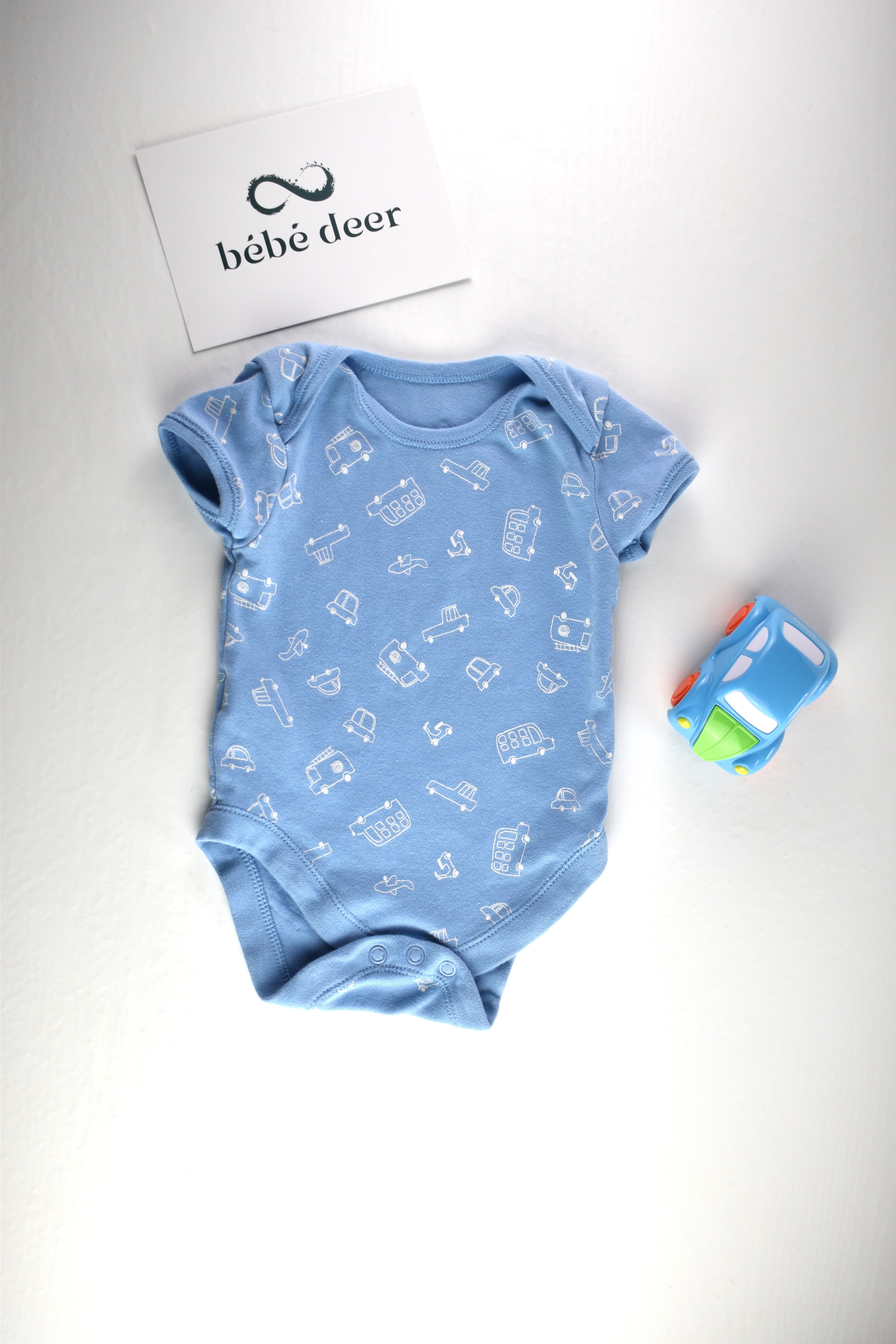 Light blue bodysuit with white vehicle print