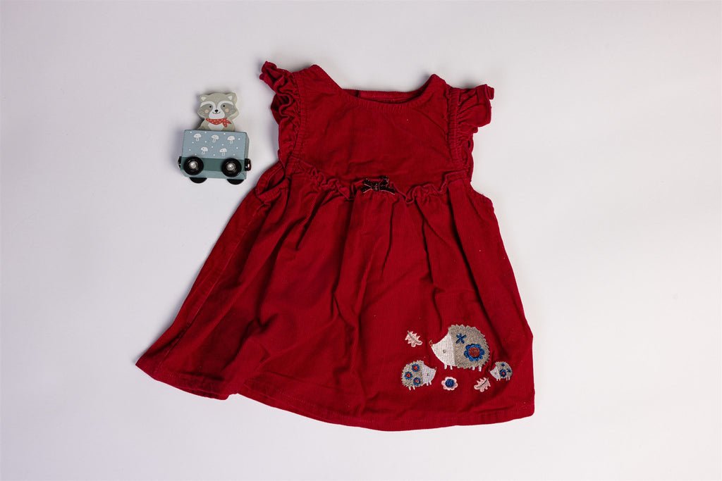 Red dress with hedgehogs and a small decorative bow